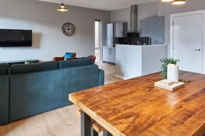 a living room with a couch and a wooden table at Ropewalks Retreat III - Sleeping 8 Guests with Parking in Liverpool