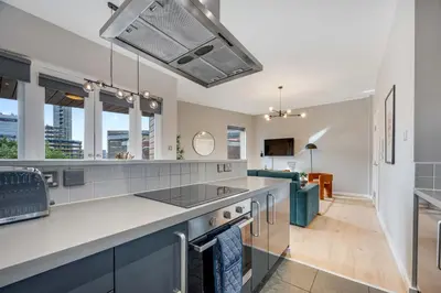 a kitchen with a counter top and some windows at Ropewalks Retreat IV Sleeping 6 Guests with Parking and Balcony in Liverpool