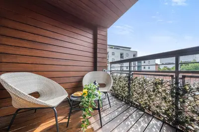 two chairs and a table on a balcony at Ropewalks Retreat IV Sleeping 6 Guests with Parking and Balcony in Liverpool