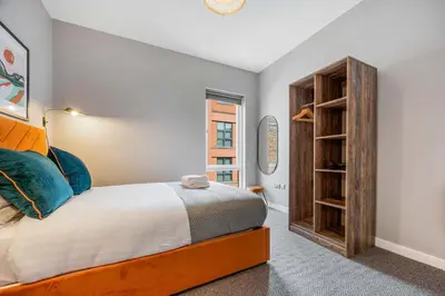 a bedroom with a bed and a book shelf at Ropewalks Retreat IV Sleeping 6 Guests with Parking and Balcony in Liverpool