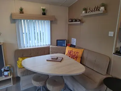 a living room with a table and a couch at 11 Borwick Lakes in Carnforth