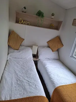 two beds in a small room withermottermottermottermott at 11 Borwick Lakes in Carnforth