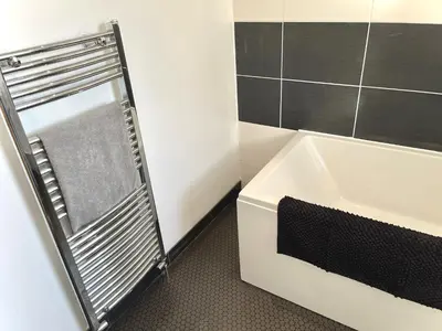 a bathroom with a bath tub and a sink at Modern 4-bed stay-away-home sleeps 8 in Preston in Preston