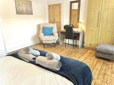 a bedroom with a bed with towels on it at Modern 4-bed stay-away-home sleeps 8 in Preston in Preston