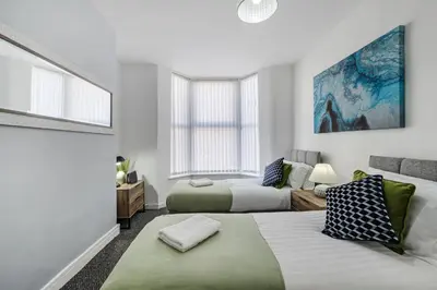 a living room with two beds and a couch at Cameron House - Air Host & Stay - Contractor Friendly in Liverpool