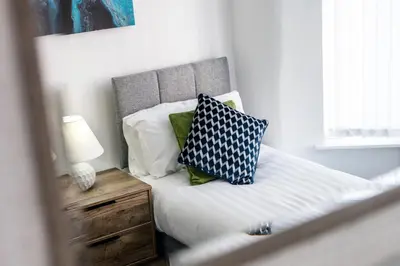 a bed with two pillows on it in a bedroom at Cameron House - Air Host & Stay - Contractor Friendly in Liverpool