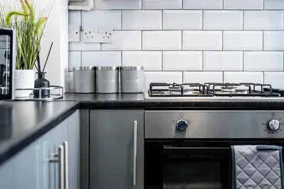 a kitchen with a stove and a counter top at Cameron House - Air Host & Stay - Contractor Friendly in Liverpool