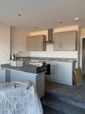 a kitchen with white cabinets and a counter top at Clock Tower Apartments No2 in Morecambe