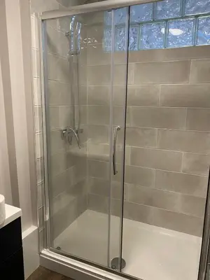 a shower with a glass door in a bathroom at Clock Tower Apartments No2 in Morecambe