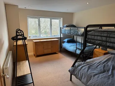 a dorm room with bunk beds and a window at Modern, sleeps 5, parking, semi rural, Upholland in Upholland