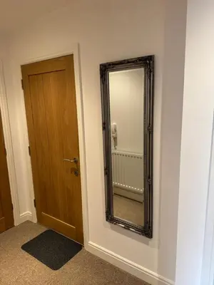 a mirror on a wall next to a door at Modern, sleeps 5, parking, semi rural, Upholland in Upholland
