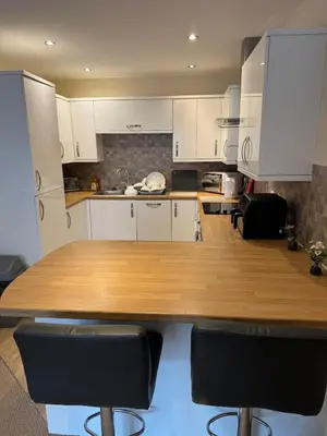 a kitchen with a wooden table and black chairs at Modern, sleeps 5, parking, semi rural, Upholland in Upholland