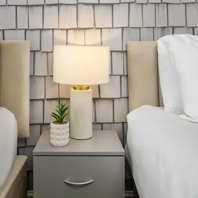 a lamp on a nightstand next to a bed at Liverpool 3 Bedroom Contractor Stay Cherry House in Liverpool