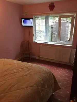 a bedroom with a bed and a window and a television at Book 3 or more nights get one night free !!! in Bare