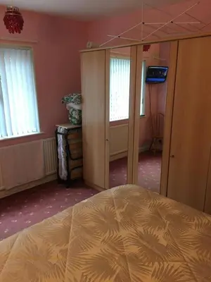 a bedroom with a bed and some windows at Book 3 or more nights get one night free !!! in Bare