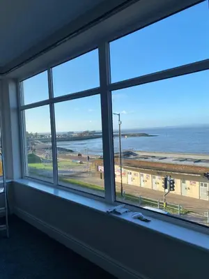 a window in a room with a view of the ocean at Clock Tower Apartments No3 in Morecambe