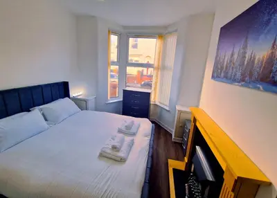 a bedroom with a bed with two towels on it at Beautiful home near LFC Stadium in Liverpool