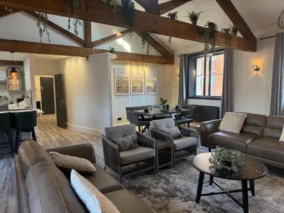 a living room with a couch and chairs and a table at Stylish city centre Penthouse in Liverpool