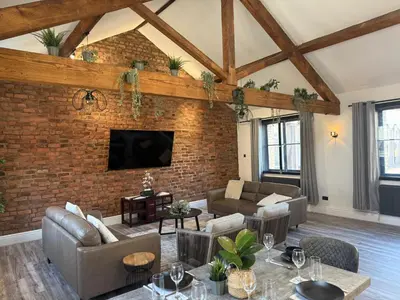 a living room with a brick wall at Stylish city centre Penthouse in Liverpool