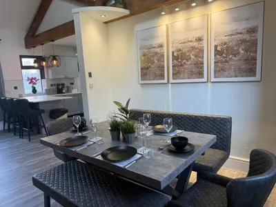 a dining room with a table and chairs at Stylish city centre Penthouse in Liverpool
