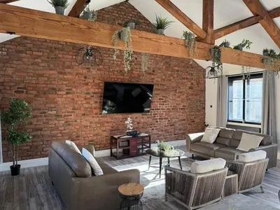 a living room with a brick wall at Stylish city centre Penthouse in Liverpool
