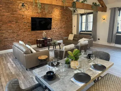 a living room with a brick wall at Stylish city centre Penthouse in Liverpool