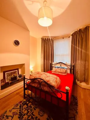 a bedroom with a bed with a red blanket at Anfield Goodison Stanley Park Liverpool in Liverpool