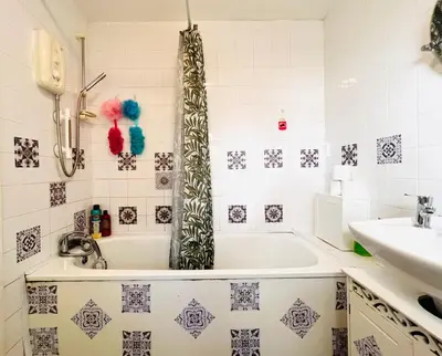 a bathroom with a tub and a sink at Anfield Goodison Stanley Park Liverpool in Liverpool