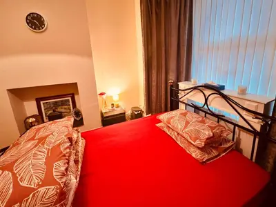 a bedroom with a bed with a red blanket at Anfield Goodison Stanley Park Liverpool in Liverpool