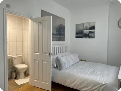 a bedroom with a bed and a toilet at Charming six bedroom townhouse citystay close to city centre in Liverpool