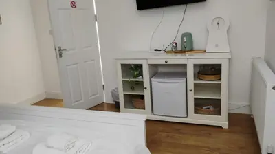 a bathroom with a sink and a white cabinet at Charming six bedroom townhouse citystay close to city centre in Liverpool