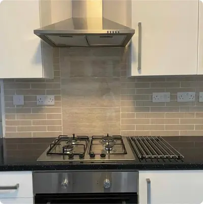 a stove top oven in a kitchen with a hood at Charming six bedroom townhouse citystay close to city centre in Liverpool