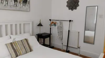 a bedroom with a bed and a mirror on the wall at Charming six bedroom townhouse citystay close to city centre in Liverpool