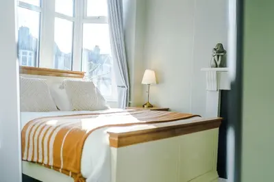 a bedroom with a bed and a window at Home in Preston 4 beds FAST WIFI in Samlesbury