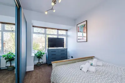 a bedroom with a bed and a flat screen tv at Home in Preston 4 beds FAST WIFI in Samlesbury