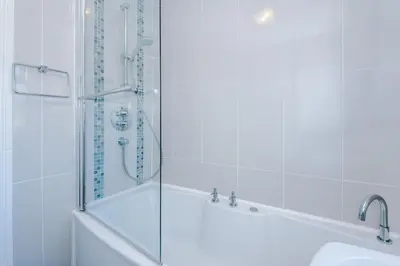 a bathroom with a shower and a tub and a sink at Home in Preston 4 beds FAST WIFI in Samlesbury