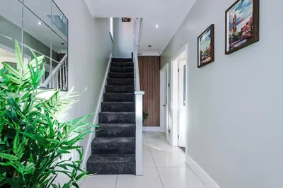 a hallway with stairs and plants in a house at Home in Preston 4 beds FAST WIFI in Samlesbury