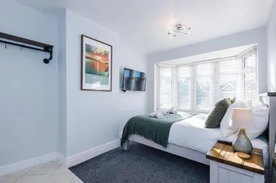 a bedroom with a bed and a window at Home in Preston 4 beds FAST WIFI in Samlesbury