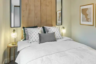 a bedroom with a large white bed with pillows at Host & Stay - Chic Townhouse by the Docks in Liverpool