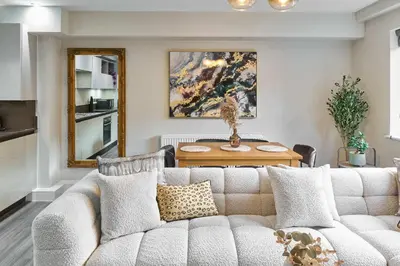 a living room with a couch and a table at Host & Stay - Chic Townhouse by the Docks in Liverpool
