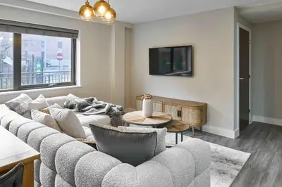a living room with a couch and a tv at Host & Stay - Chic Townhouse by the Docks in Liverpool