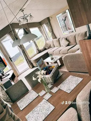 a living room with a couch and a table at Metcalfes family caravan in Heysham