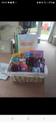 a basket filled with different types of candy on a table at Metcalfes family caravan in Heysham