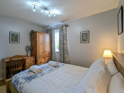 a bedroom with a bed and a desk and a window at Vintage 2-Bed City Centre Gem Free Parking in Liverpool