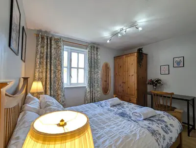 a bedroom with a bed and a desk and a window at Vintage 2-Bed City Centre Gem Free Parking in Liverpool