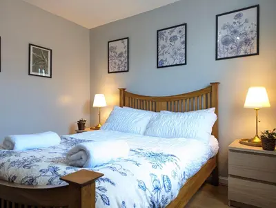 a bedroom with a bed with two pillows on it at Vintage 2-Bed City Centre Gem Free Parking in Liverpool
