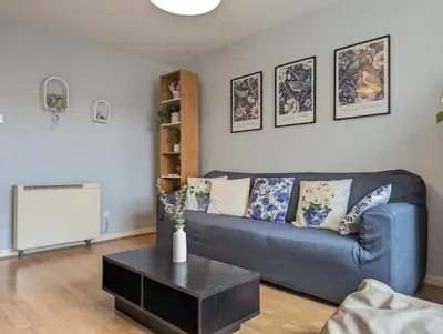 a living room with a blue couch and a table at Vintage 2-Bed City Centre Gem Free Parking in Liverpool