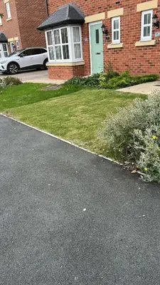 a house with a green door and a grass yard at Spacious Luxurious Serviced Accommodation 7 in Preston