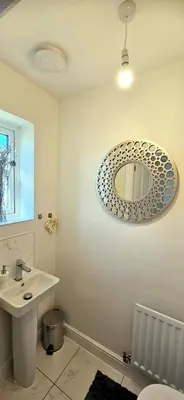 a bathroom with a sink and a mirror on the wall at Spacious Luxurious Serviced Accommodation 7 in Preston