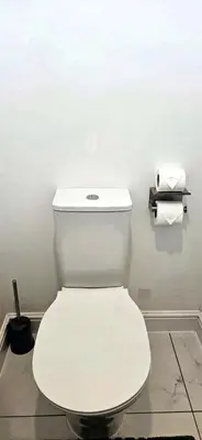 a white toilet in a bathroom with two rolls of toilet paper at Spacious Luxurious Serviced Accommodation 7 in Preston